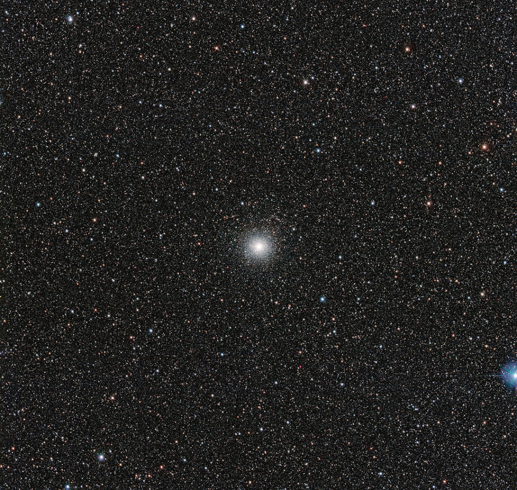 This image from the VLT Survey Telescope at ESO’s Paranal Observatory in northern Chile shows the globular cluster Messier 54. This cluster looks very similar to many others, but it has a secret. Messier 54 doesn’t belong to the Milky Way, but actually is part of a small satellite galaxy, the Sagittarius Dwarf Galaxy. This unusual parentage has allowed astronomers to use the Very Large Telescope (VLT) to test whether unexpectedly low levels of the element lithium in stars are also found in stars outside the Milky Way. Image: ESO, 2014.